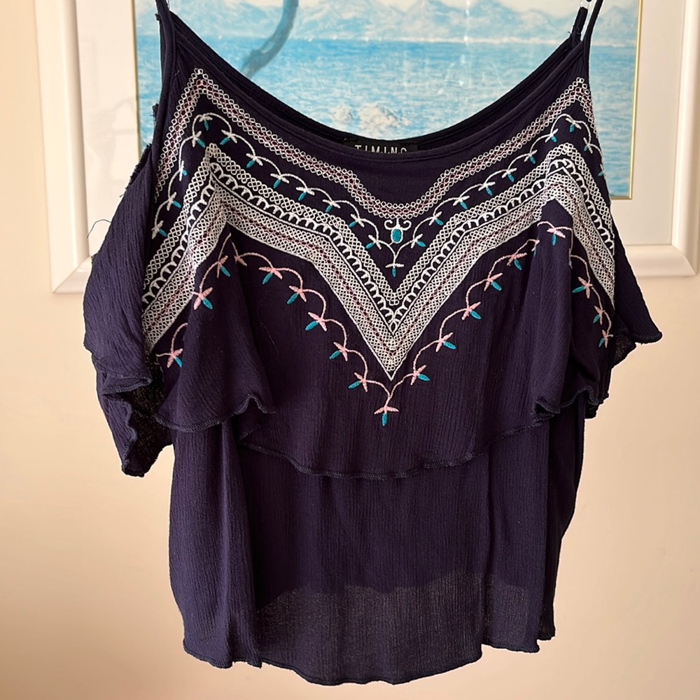 Blue cropped tank with a layer of ruffle and off the shoulder cap sleeves.